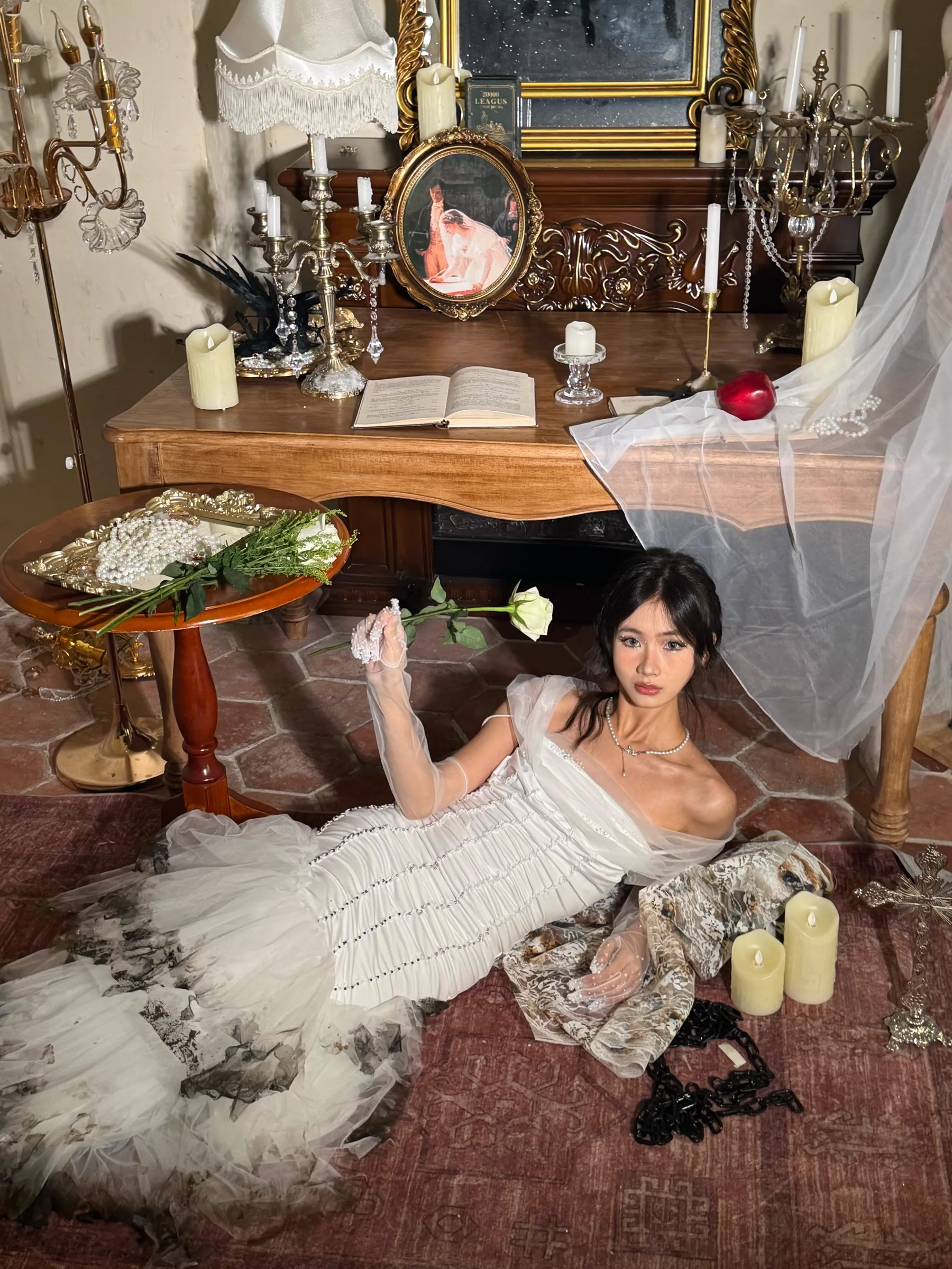 Model wearing a translucent white layered garment in an interior installation