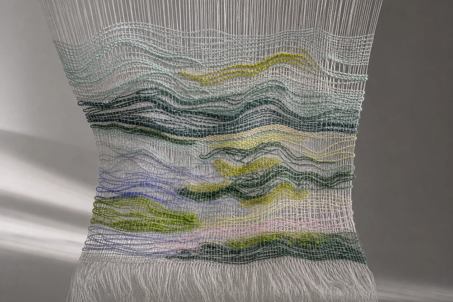 Physical handwoven landscape with undulating coloured weft